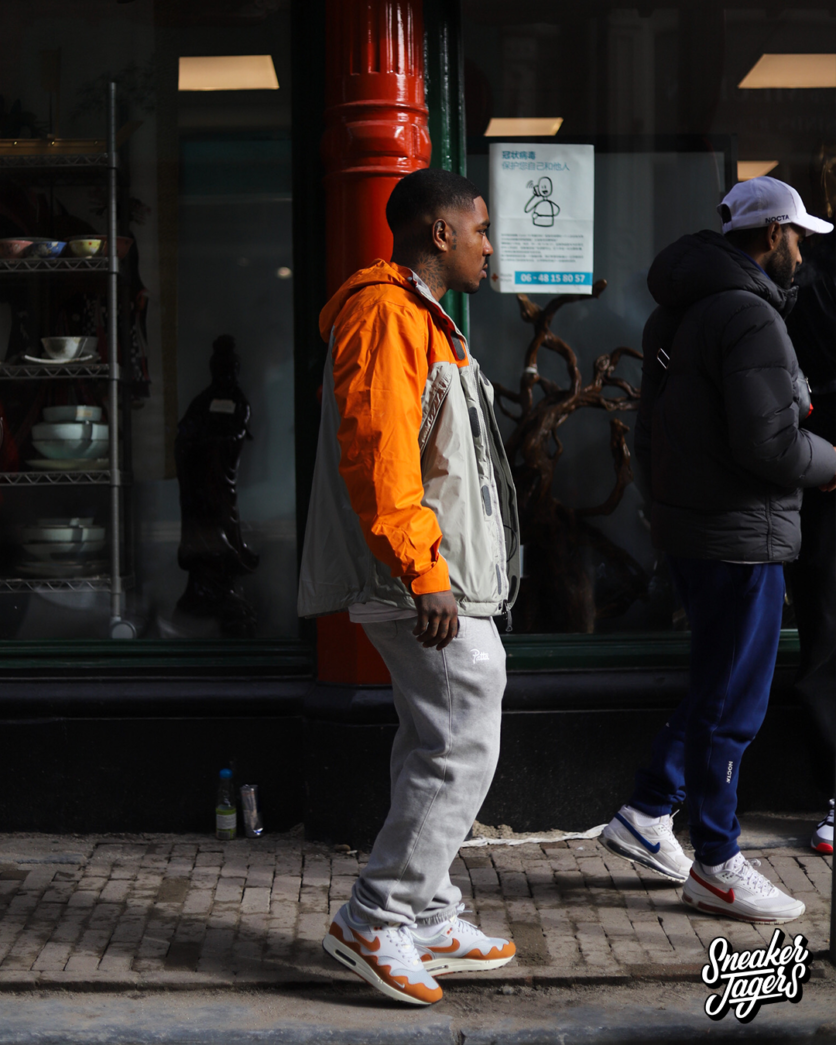 outside patta amsterdam for patta x nike air max 1 monarch the wave release - man wearing the sneakers